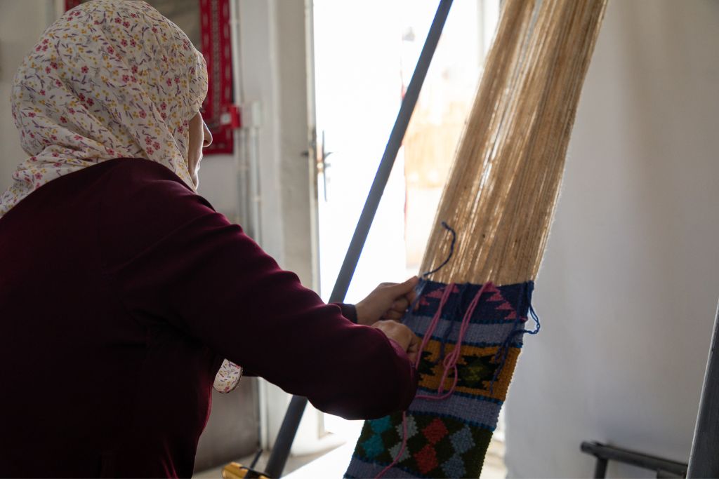 woman weaving textiles: cultural conservation